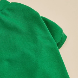 Close-up of green pique knit cotton pet vest showing premium fabric texture and seams