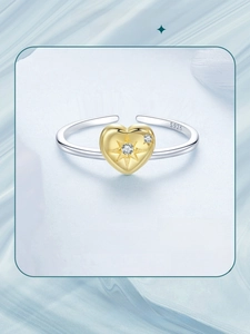 Detail of S925 sterling silver adjustable ring with gold heart pendant and zircon star inlay