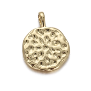 Detailed macro view of golden circular pendant with unique hammered texture and top ring