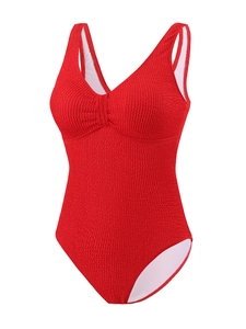 Gros plan du tissu de maillot de bain rouge texturé avec détails froncés et décolleté en V