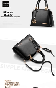 Detail of black lychee grain leather tote bag with gold logo and adjustable shoulder strap