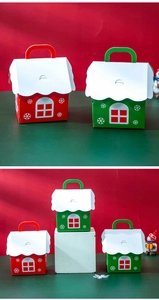 Detail of house-shaped Christmas gift boxes with snowflake patterns and handles