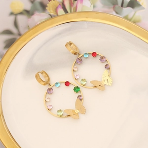 Detailed close-up of golden hoop earrings with colorful crystals and butterfly charms