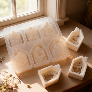Macro view of house-shaped silicone mold with sun and tree patterns for DIY crafts