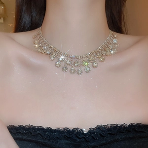 Macro shot of a sparkling crystal flower choker necklace worn on a neck in warm light