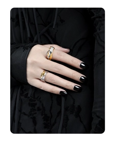 Close-up of S925 sterling silver rings with gold plating and textured striped patterns
