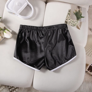 Close-up of black satin athletic shorts with white trim and elastic high waist design