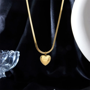 Golden heart pendant necklace with Love You More engraving on a flat snake chain