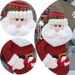 Detail of 50cm linen Christmas stocking showing Santa Claus face and knit textures