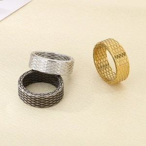 Detail of vintage textured stainless steel rings in gold, silver, and black colors