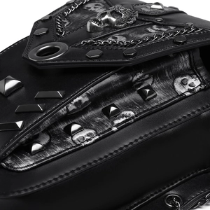 Close-up of distressed leather punk bag with skull studs and metallic chain accents