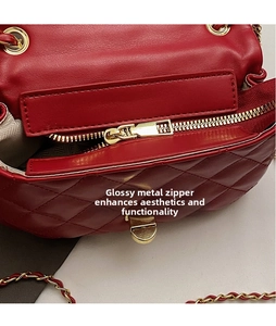 Detail of premium red quilted leather bag featuring a polished gold zipper and hardware