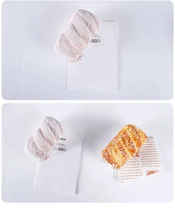 Macro shot of realistic artificial cupcakes with white powder and sesame seeds on liners