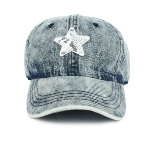 Detailed close-up of sequined star on denim baseball cap with premium stitching