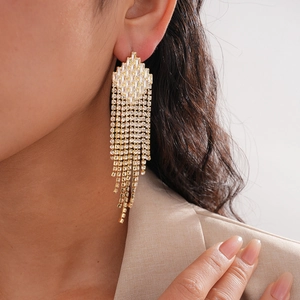 Macro shot of gold tassel earrings with cascading cubic zirconia and silver needles