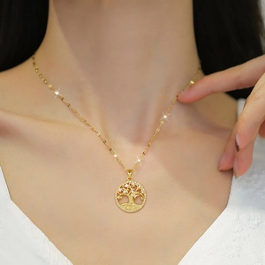 Elegant gold tree of life necklace with pavé cubic zirconia worn by a female model