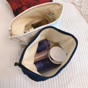 Detail view of large floral jacquard makeup bags with zipper closure and spacious interior