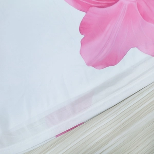 Detailed view of lightweight white mesh fabric with elegant large pink floral patterns