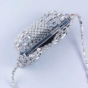 Close-up of a silver woven metal mesh phone bag showing internal space for a smartphone
