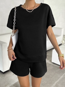 Detail view of black textured knit short sleeve top and matching shorts set for women