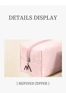 Macro detail of pink floral embossed PU leather and creative M-shaped metal zipper puller