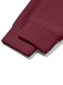 Detail shot of burgundy ribbed knit cuffs showing high-elasticity texture and stitching