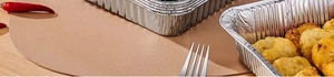 Close-up of food-grade aluminum foil containers with fried chicken on a wooden table