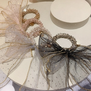 Macro view of crystal beaded hair ties with sequined mesh bows in multiple colors