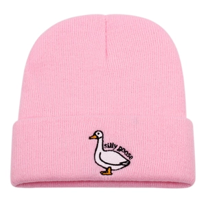 Close-up of pink ribbed knit beanie featuring detailed silly goose cartoon embroidery