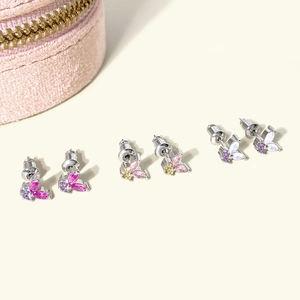 Detailed macro view of butterfly stud earrings with colorful zircon stones in gold plating