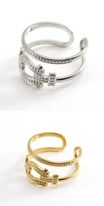 Detail view of belt buckle style adjustable rings in polished gold and silver steel finish