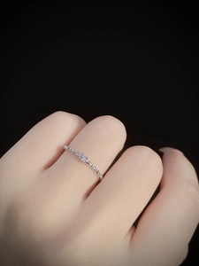 Close-up of S925 sterling silver twist ring with a sparkling white zircon on finger