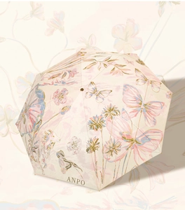Detail of warm beige sun umbrella with hand-painted butterfly and floral print designs