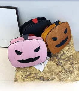 Detailed view of Halloween pumpkin crossbody bags in pink, black, and orange glitter finish