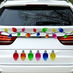 Close-up of colorful Christmas bulb magnetic stickers on a white SUV for holiday decor