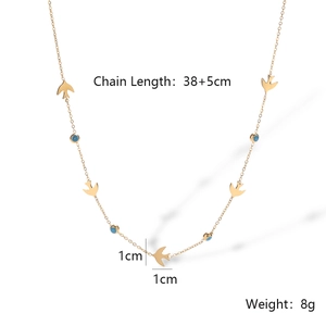 Detail view of 18K gold-plated necklace with blue evil eye bead and bird charm