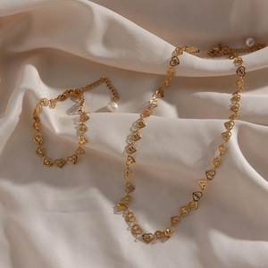 Elegant gold heart link necklace and bracelet jewelry set with pearl drop detail