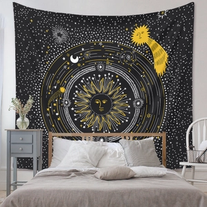 Detail of bohemian celestial tapestry with golden sun and moon icons for wall decor
