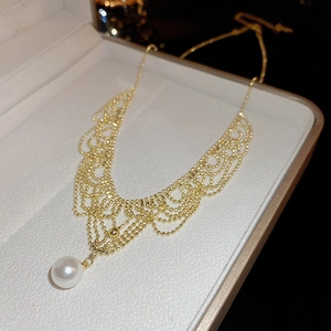 Detailed close-up of 24K gold plated lace necklace with a lustrous white pearl pendant