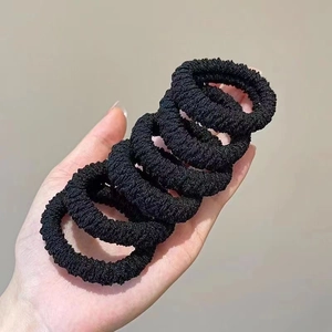 Close-up of 6-piece black thick elastic hair ties with durable knitted texture