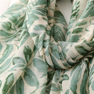 Detailed macro view of tropical green banana leaf print on lightweight cotton linen fabric