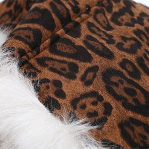Detailed close-up of leopard print fabric and white faux fur texture on a winter trapper hat