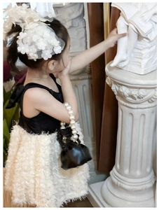 Elegant white flower and pearl headband detail for a little girl classic princess style