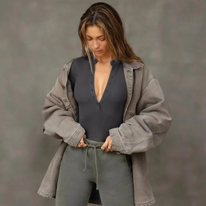 Detail of dark grey ribbed knit long sleeve bodysuit with a deep V-neck and button closure
