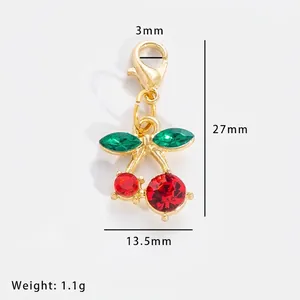Macro view of cherry charm with red and green rhinestones and dimensions 27x13.5mm