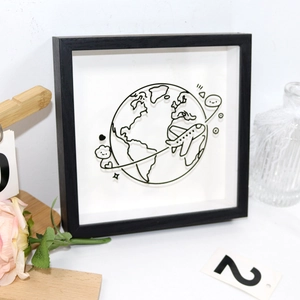 Close-up of a black ticket shadow box frame with minimalist 3D world map illustration