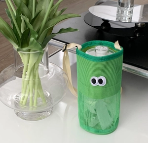 Detail of green mesh water bottle bag with cute eyes embroidery and beige strap