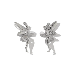 Close-up of silver elf earrings with white pearls and polished stainless steel finish