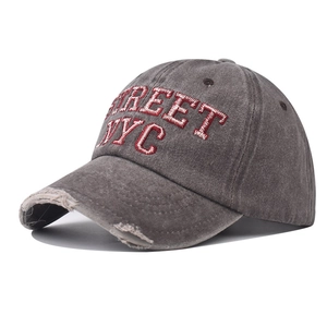 Detailed shot of vintage washed grey cotton baseball cap with red Street NYC embroidery