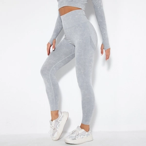 Detail of high-waist acid wash yoga pants with seamless texture and breathable side mesh